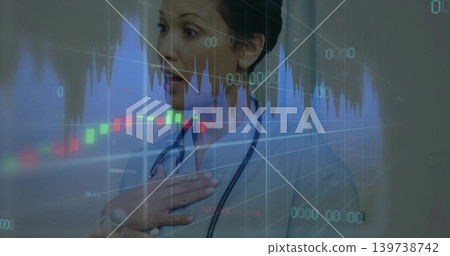 Reacting physician pressing hand to chest in clinic, wearing lab coat and stethoscope with charts 139738742