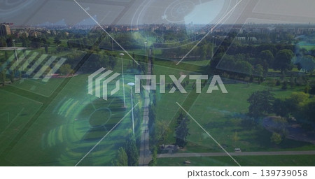 Stretching central tree-lined walkway through urban park, showing lamp posts, benches, pond and HUD 139739058