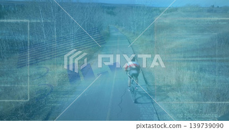 Pedaling teenage cyclist riding on rural paved road with road bicycle, helmet, jersey, copy space 139739090