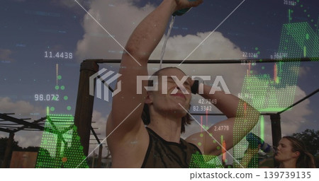 Tilting woman wearing tank top pouring water over head at workout rig, AR overlay and smartwatch Tilting woman wearing tank top pouring water over head at workout rig, AR overlay and smartwatch 139739135