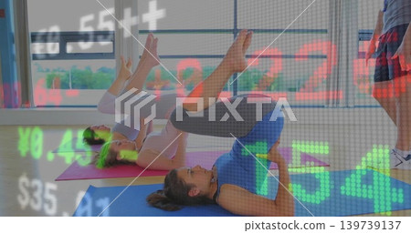 Lifting woman in tank top and leggings on mat raising hips at studio, with ticker overlay Lifting woman in tank top and leggings on mat raising hips at studio, with ticker overlay 139739137