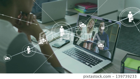 Watching woman in short-sleeve top leaning toward laptop at office, with smartphone, copy space Watching woman in short-sleeve top leaning toward laptop at office, with smartphone, copy space 139739233