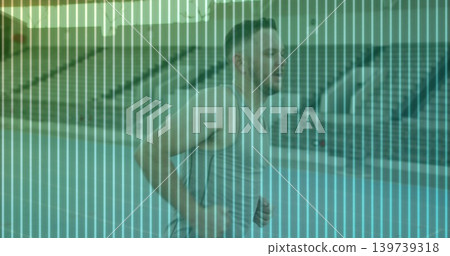 Running midadult runner passing bleachers on track in gray sleeveless top, shorts, teal overlay Running midadult runner passing bleachers on track in gray sleeveless top, shorts, teal overlay 139739318
