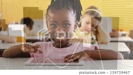 Smiling African American student using tablet at elementary classroom, wearing pink shirt, graphs Smiling African American student using tablet at elementary classroom, wearing pink shirt, graphs 139739467