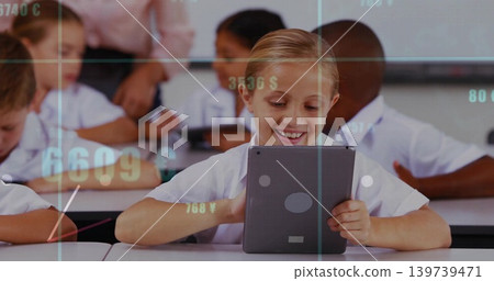 Smiling girl holding vertical tablet at school desk, teacher wearing suit watching numeric overlay Smiling girl holding vertical tablet at school desk, teacher wearing suit watching numeric overlay 139739471