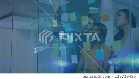 Reaching man in dark shirt placing sticky note on glass wall at office, with digital overlays Reaching man in dark shirt placing sticky note on glass wall at office, with digital overlays 139739480