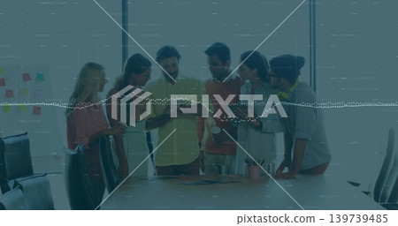 Leaning six colleagues in business attire studying smartphone at conference table, sticky notes Leaning six colleagues in business attire studying smartphone at conference table, sticky notes 139739485