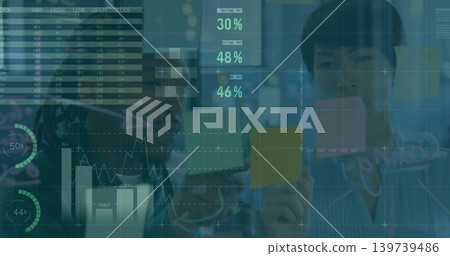 Placing sticky notes, team organizing data on glass in office wearing business casual HUD overlays 139739486