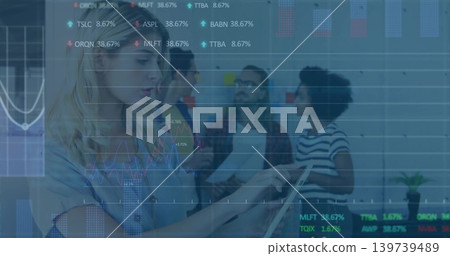 Tapping tablet, woman in blue top at office, team reading papers, sticky notes, charts, copy space Tapping tablet, woman in blue top at office, team reading papers, sticky notes, charts, copy space 139739489
