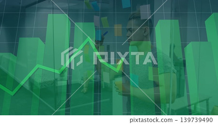 Pointing man in workwear holding marker, cup at office glass wall with sticky notes, green overlay 139739490