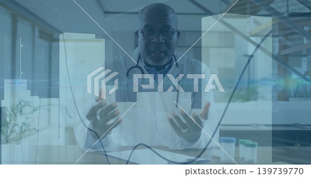 Gesturing senior doctor explaining care in clinic, wearing white lab coat, stethoscope, data charts Gesturing senior doctor explaining care in clinic, wearing white lab coat, stethoscope, data charts 139739770