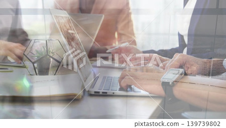 Typing colleagues' hands pressing keys at meeting table, laptop and terrarium in business-casual Typing colleagues' hands pressing keys at meeting table, laptop and terrarium in business-casual 139739802