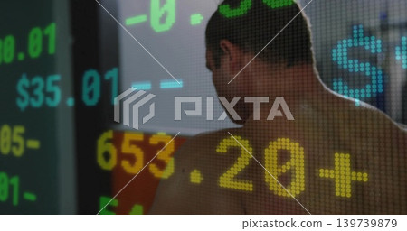 Turning adult male showing bare back and shoulders in office, displaying pixelated dollar numerals Turning adult male showing bare back and shoulders in office, displaying pixelated dollar numerals 139739879
