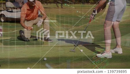 Putting woman in shorts, kneeling partner lining up putt on green with golf balls, market data Putting woman in shorts, kneeling partner lining up putt on green with golf balls, market data 139739895