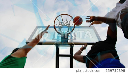 Leaping players reaching toward hoop and ball on outdoor court, green jersey white tee blue shorts Leaping players reaching toward hoop and ball on outdoor court, green jersey white tee blue shorts 139739896