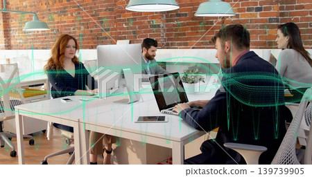 Working team of four in blazers typing and discussing in open-plan office, with monitors Working team of four in blazers typing and discussing in open-plan office, with monitors 139739905