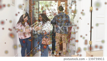 Greeting six adults embracing and exchanging bouquet in home entryway, handbag, pink checked top Greeting six adults embracing and exchanging bouquet in home entryway, handbag, pink checked top 139739911