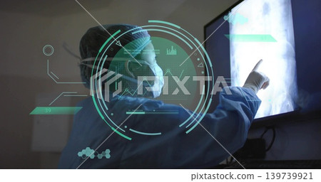 Pointing female doctor in scrubs and mask examining X-ray display in radiology room, teal AR HUD Pointing female doctor in scrubs and mask examining X-ray display in radiology room, teal AR HUD 139739921