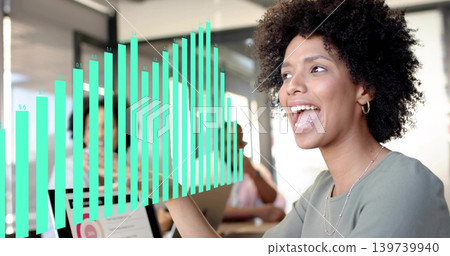 Presenting woman in light green top and hoop earrings gesturing in office, laptop, teal overlay Presenting woman in light green top and hoop earrings gesturing in office, laptop, teal overlay 139739940