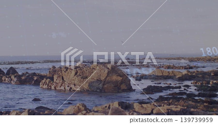 Showing large jagged rock rising from shallow surf at rocky coast, with digital overlay 180 Showing large jagged rock rising from shallow surf at rocky coast, with digital overlay 180 139739959