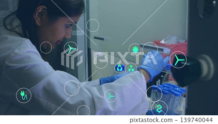 Leaning lab-tech handling blue tubes at lab bench, lab-coat, blue gloves, holo icons, copy space Leaning lab-tech handling blue tubes at lab bench, lab-coat, blue gloves, holo icons, copy space 139740044