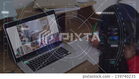 Displaying laptop showing remote classroom on home desk, with child writing using green pencil Displaying laptop showing remote classroom on home desk, with child writing using green pencil 139740235