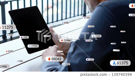 Tapping man in dark long-sleeve shirt with black tablet on balcony, notification badges, copy space Tapping man in dark long-sleeve shirt with black tablet on balcony, notification badges, copy space 139740399