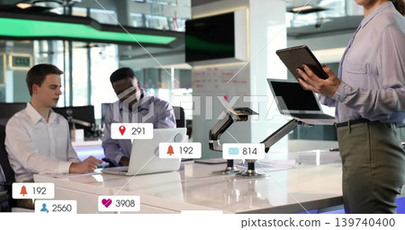 Working team sitting at glossy table, using laptops, tablet, wearing office attire, with icons Working team sitting at glossy table, using laptops, tablet, wearing office attire, with icons 139740400