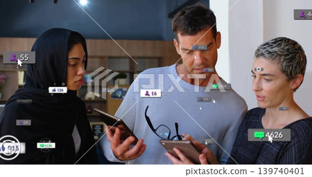 Examining three colleagues with hijab holding smartphone, tablet in modern office, notifications Examining three colleagues with hijab holding smartphone, tablet in modern office, notifications 139740401