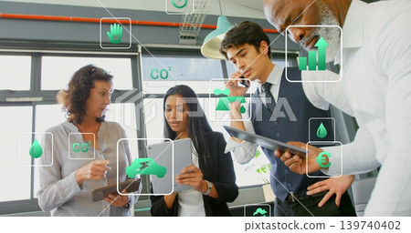 Discussing four team staff in business attire using tablets and phone at office with green overlays Discussing four team staff in business attire using tablets and phone at office with green overlays 139740402