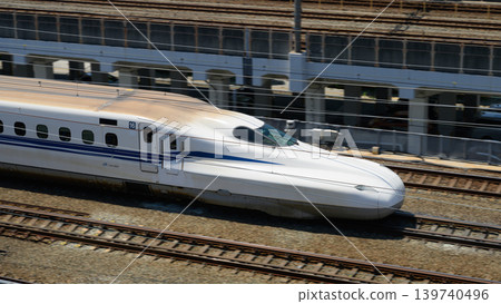 JR West's N700S Shinkansen speeds along an elevated track. 139740496