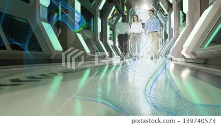 Walking group of three professionals moving toward camera in futuristic corridor, holographic floor Walking group of three professionals moving toward camera in futuristic corridor, holographic floor 139740573