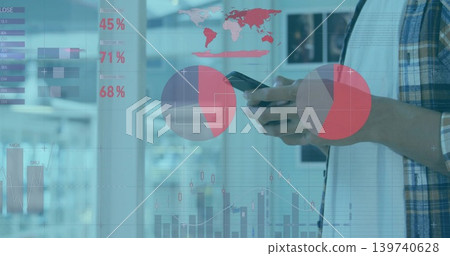 Holding smartphone, man in plaid shirt checking overlays near glass partition at office, copy space Holding smartphone, man in plaid shirt checking overlays near glass partition at office, copy space 139740628