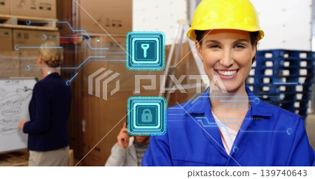 Smiling woman in yellow hard hat, blue coveralls sorting cartons in warehouse with security icons 139740643