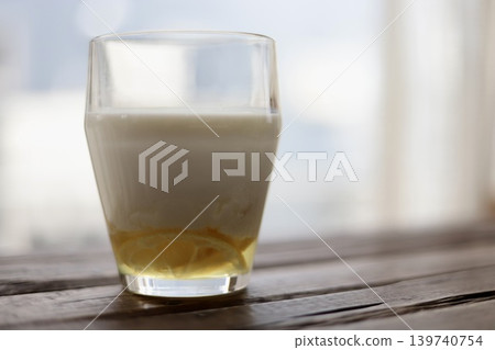 Lemon lassi made with homemade lemon syrup placed on the windowsill. 139740754