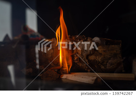 Cinematic reflection of flame on sleek surface. Atmospheric scene with luminous streaks and moody shadows 139742267