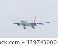 Mai Khao Phuket Thailand 2025 11 25: Nordwind Airlines Boeing 777-200ER prepares to land over Mai Khao Beach, approaching Phuket Airport in Thailand on a clear day with a blue sky. High quality photo 139743000