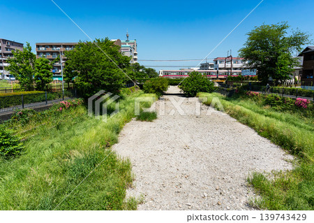 The parched Nogawa River; a view of the Keio Line from Kurumabashi Bridge; Kikunodai, Chofu City, Tokyo 139743429