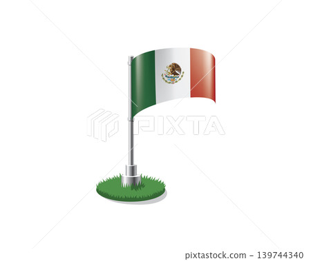 Mexican flag on a flagpole mounted on the grass 139744340