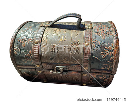 A small wooden treasure chest features metal rivets and a leather handle. It has embossed floral patterns and Chinese characters on its curved lid. The chest is isolated on a clean surface. A small wooden treasure chest features metal rivets and a leather handle. It has embossed floral patterns and Chinese characters on its curved lid. The chest is isolated on a clean surface. 139744445