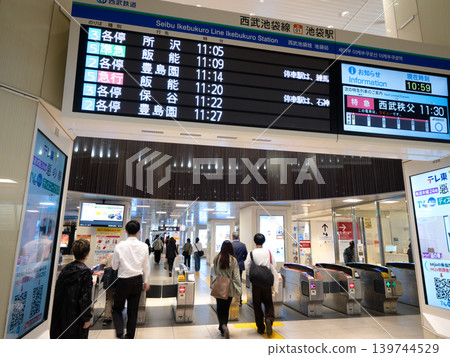 Ticket gates and departure information display boards at Seibu Ikebukuro Station, Tokyo. Ticket gates and departure information display boards at Seibu Ikebukuro Station, Tokyo. 139744529