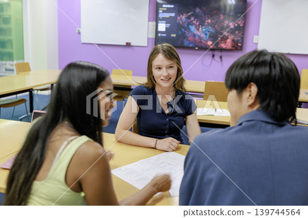 教室裡,一男一女一邊看著一幅畫一邊討論。 教室裡,一男一女一邊看著一幅畫一邊討論。 139744564
