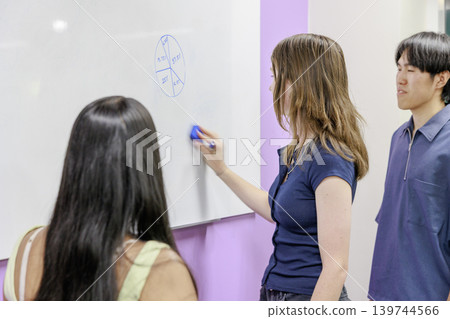 International university students using whiteboards for learning. International university students using whiteboards for learning. 139744566