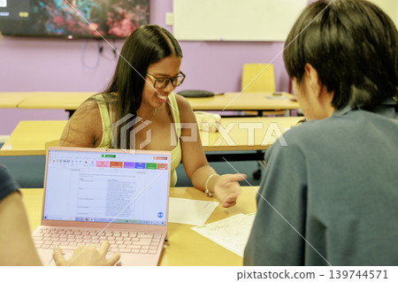 Young men and women having a discussion in a university classroom Young men and women having a discussion in a university classroom 139744571