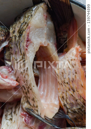 Close view of fish pieces placed in a bowl on a kitchen counter. These pieces are prepared for cooking during the morning Close view of fish pieces placed in a bowl on a kitchen counter. These pieces are prepared for cooking during the morning 139744899