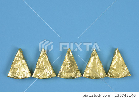 Triangular processed cheese portions in gold foil Triangular processed cheese portions in gold foil 139745146