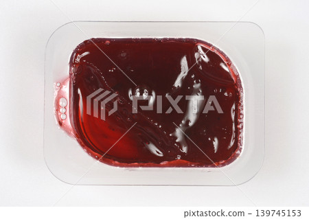 Cranberry jam in a transparent plastic container 139745153