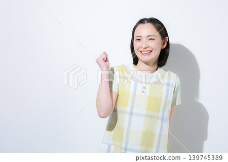 Against a white background, smiling and cheering women such as childcare workers, caregivers, and mothers are shown looking directly at the camera, offering support for job changes and recruitment. 139745389