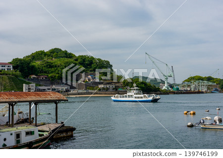 A view of Mukaijima Island and the ferry from Onomichi: The tranquil scenery of the Shimanami Kaido. A view of Mukaijima Island and the ferry from Onomichi: The tranquil scenery of the Shimanami Kaido. 139746199
