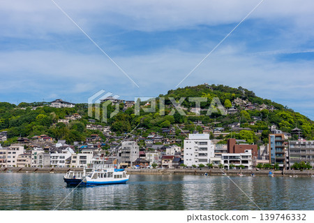 A view of the ferry and the townscape of Onomichi from Mukaijima Island, and the scenery of the Seto Inland Sea. A view of the ferry and the townscape of Onomichi from Mukaijima Island, and the scenery of the Seto Inland Sea. 139746332